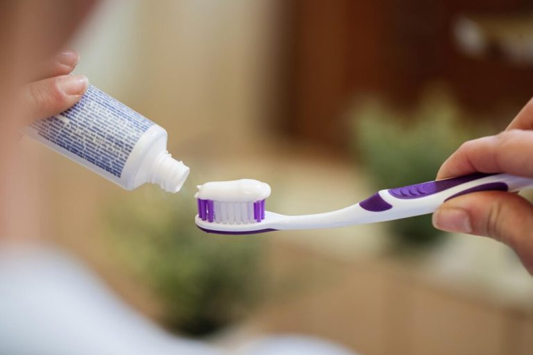 closeup unrecognizable woman applying toothpaste toothbrush bathroom 637285 3688